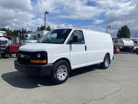 A white 2009 Chevrolet Express van is parked with its side facing the viewer showcasing its sleek design and wheels
