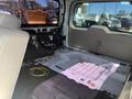 Interior view of a 2013 Ford Expedition showing stripped seating and floor with visible wires and a clean, empty cargo area