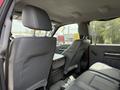 Interior of a 2013 Ford F-550 showing two front seats with a center console visible between them and gray upholstery