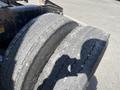 A close-up view of the rear tires of a 2022 Freightliner Cascadia showing wear and tread pattern details