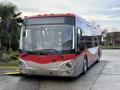 A 2016 Grande West Vicinity bus featuring a red and silver exterior with a prominent front grille and large windows