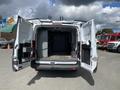 A 2019 Ford Transit van with its back doors open revealing a spacious interior with shelves and storage compartments