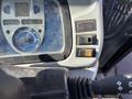Close-up of the control panel of a 2010 New Holland T4050 displaying gauges switches and buttons