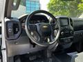 Interior of a 2021 Chevrolet Silverado 1500 featuring a modern dashboard a steering wheel with the Chevrolet emblem and control panels for audio and climate settings