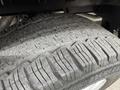 Close-up of a worn tire on a 2017 Ford Transit showing visible tread patterns and dirt accumulation on the rubber surface