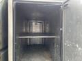 The interior of a 2008 Mitsubishi Fuso FE180 showing a spacious metal cargo area with a sliding shelf along one wall