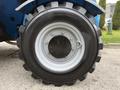 Close-up of the wheel of a 2020 Genie GTH-5519 featuring a heavy-duty tire with deep treads and a metallic rim secured with bolts