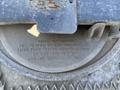 Close-up of a metal plate showing specifications for a 2009 International 7500 truck including model number pressure ratings and flow rates