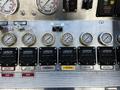 Control panel of a 2006 Emergency One Fire Truck featuring various pressure gauges and discharge controls with labeled buttons and switches