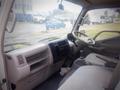 Interior of a 2003 Toyota Toyoace showing the dashboard gear shift and passenger seat