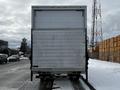 A white 2019 Hino 338 24 foot cube truck viewed from the rear with a flat surface and no visible markings