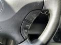 Close-up of the steering wheel of a 2012 Mercedes-Benz Sprinter featuring control buttons for volume and phone functions