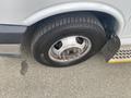 A 2018 Chevrolet Express van showing a close-up of its tire and wheel assembly with wheel bolts visible