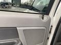 Interior view of a 2008 Dodge Ram 5500 door with a textured gray panel and a speaker grille near the handle