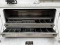 A metal storage compartment with two pull-out drawers featuring multiple dividers for organizing tools or equipment