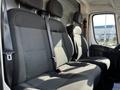 Interior seating of a 2017 RAM Promaster featuring two upholstered front seats with seat belts and headrests