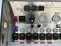 Control panel of a 2006 Emergency One Fire Truck featuring gauges switches and knobs for various functions and indicators for foam and water operations