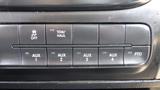 A close-up view of the dashboard controls of a 2014 RAM 5500 featuring buttons for off, tow/haul, and four auxiliary functions