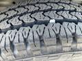 Close-up of a tire tread pattern on a 2012 Chevrolet Express showing deep grooves and rubber texture designed for traction and stability