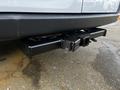 A black trailer hitch mounted on the rear of a 2022 Mercedes-Benz Sprinter