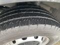 Close-up of a wet tire from a 2018 Ford Transit showing tread pattern and rim details