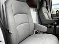 A gray fabric seat from a 2009 Ford Econoline showing a high back with armrests and a simple design without visible markings