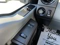 Interior dashboard control panel of a 2011 Ford F-350 SD featuring buttons for window controls and dial for adjusting air flow