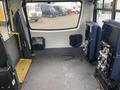 Interior view of a 2016 Chevrolet Express van showing empty seating area with metallic floor and two front seats positioned against the walls