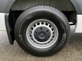 A close-up of a 2021 Mercedes-Benz Sprinter tire featuring a silver wheel with ventilation holes and a Michelin Agilis tire model