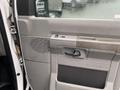 Interior door panel of a 2011 Ford Econoline with a textured design and handle visible