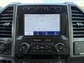 The interior dashboard of a 2020 Ford F-350 SD featuring a central touchscreen display with audio settings and controls for navigation and phone connectivity