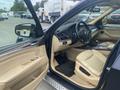 Interior view of a 2009 BMW X5 showing beige leather seats dashboard and steering wheel