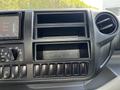 Dashboard of a 2020 Hino 155 featuring an infotainment screen multiple storage compartments and climate control buttons