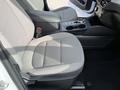 Interior view of a 2020 Ford Escape focusing on the driver's seat featuring fabric upholstery and a console with controls