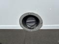 Fuel filler cap of a 2020 Chevrolet Express with a black round cover secured by a metal ring