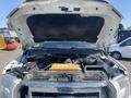 A 2017 Ford F-150 with its hood raised revealing the engine compartment and various components inside