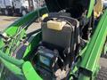 A 2008 John Deere 3320 tractor with a 300X loader displaying the engine compartment and battery components