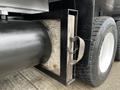 A 2017 International WorkStar 7600 showing a cylindrical tank connected to a rectangular wooden box secured with a strap