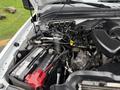 The image shows the engine compartment of a 2008 Ford F-250 Super Duty with various components including hoses battery and engine parts visible