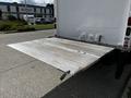 A rear loading ramp extended from a 2016 Isuzu NQR truck showing a metal surface designed for easy access and loading of cargo