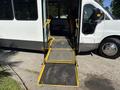A 2017 Chevrolet Express with a lowered ramp for accessibility at the entrance area of the vehicle