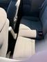 Interior view of a 2003 Ford Mustang showing a gray fabric rear seat with seatbelts and a center armrest