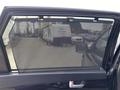 A 2015 Kia Sorento with a mesh sunshade installed on the rear window