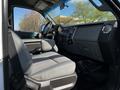 Interior of a 2016 Ford F-550 truck showing front seats and dashboard with a focus on the gray upholstery and control panel
