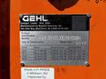 A metal identification plate attached to a 2017 Gehl R105 compact loader displaying product information and specifications