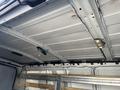 Interior of a 2016 GMC Savana showing the ceiling structure with metal beams and a light fixture attached