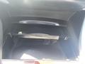A close-up view of the glove compartment of a 2017 Acura TLX featuring an open drawer with a push latch mechanism