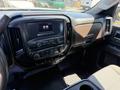 Interior dashboard of a 2016 GMC Sierra 1500 featuring a touchscreen display and climate control buttons