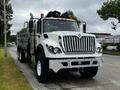 A 2017 International WorkStar 7600 truck featuring a large front grille multiple headlights and a dump bed in the rear with a high clearance design