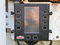 Control panel with multiple buttons and a screen labeled Summit Truck Bodies